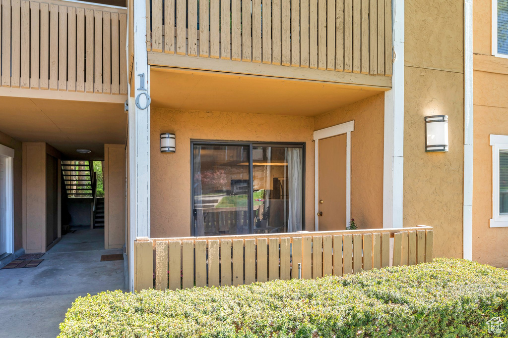 Property entrance featuring stucco siding