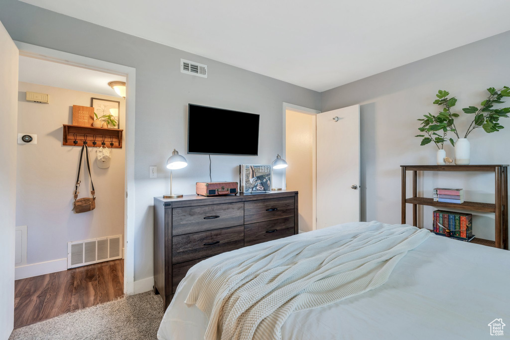 Bedroom with visible vents, baseboards, and carpet floors