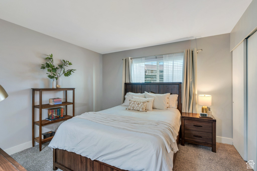 Bedroom featuring light colored carpet and baseboards