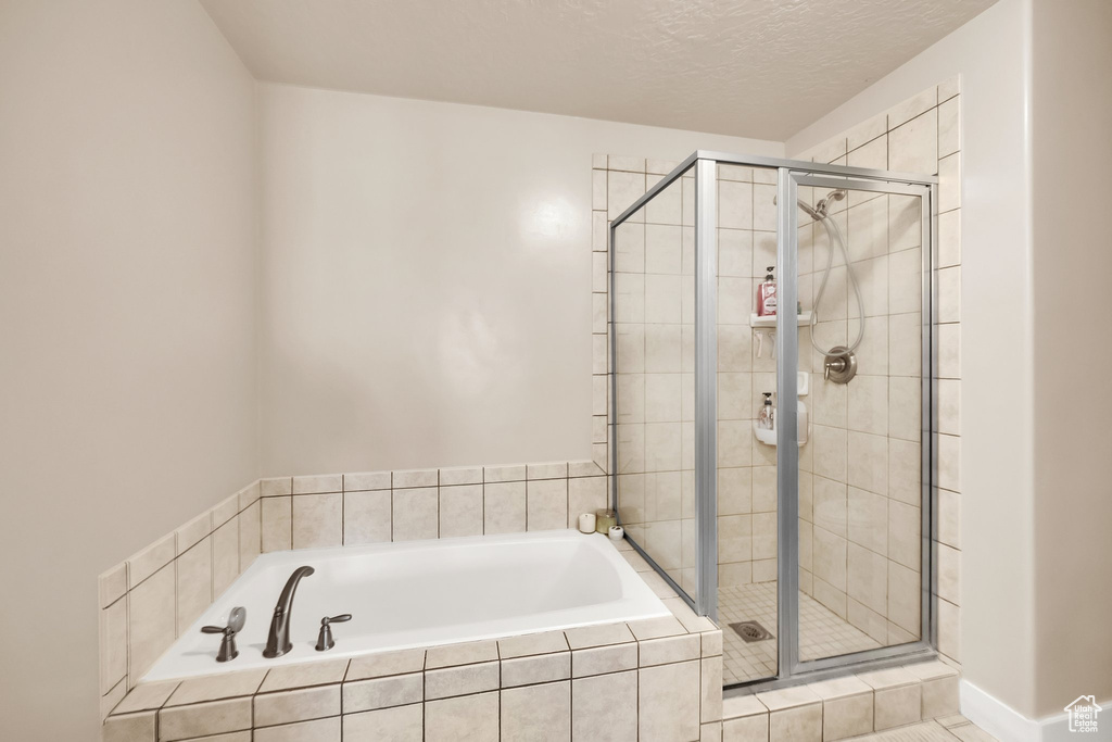 Bathroom featuring a bath and a stall shower