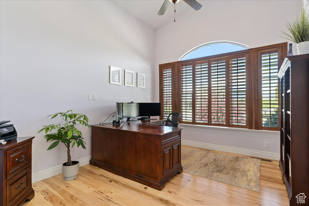 Office featuring light wood-style floors, a ceiling fan, and baseboards