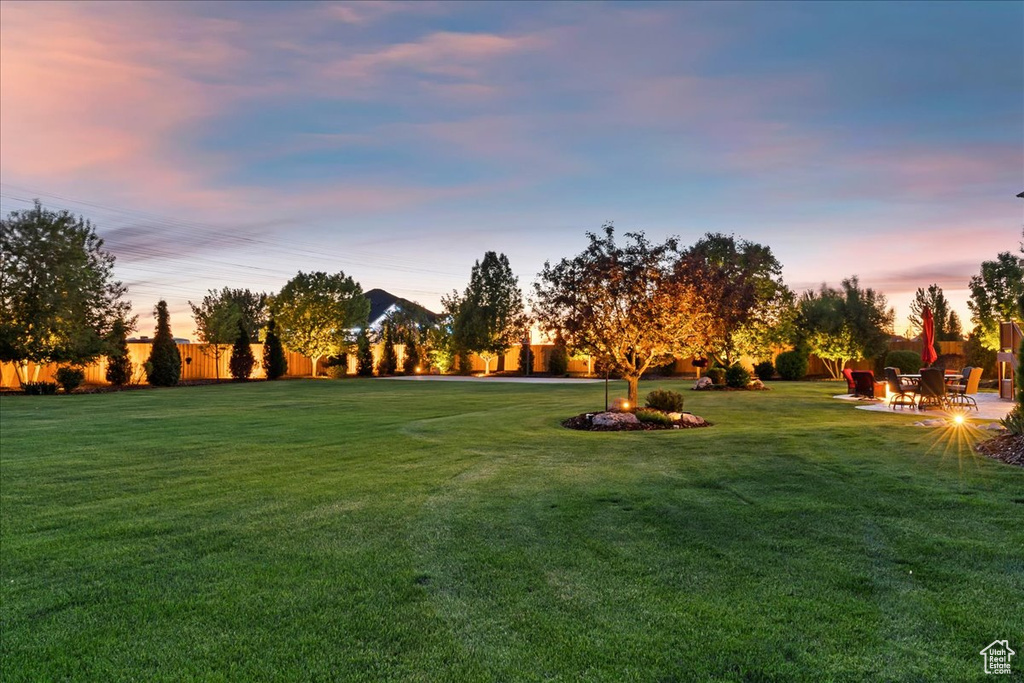 View of property\\\'s community featuring a yard and a patio area