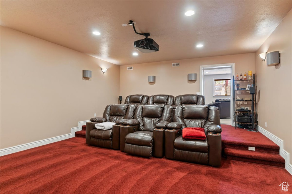 Carpeted cinema room featuring recessed lighting, baseboards, and visible vents