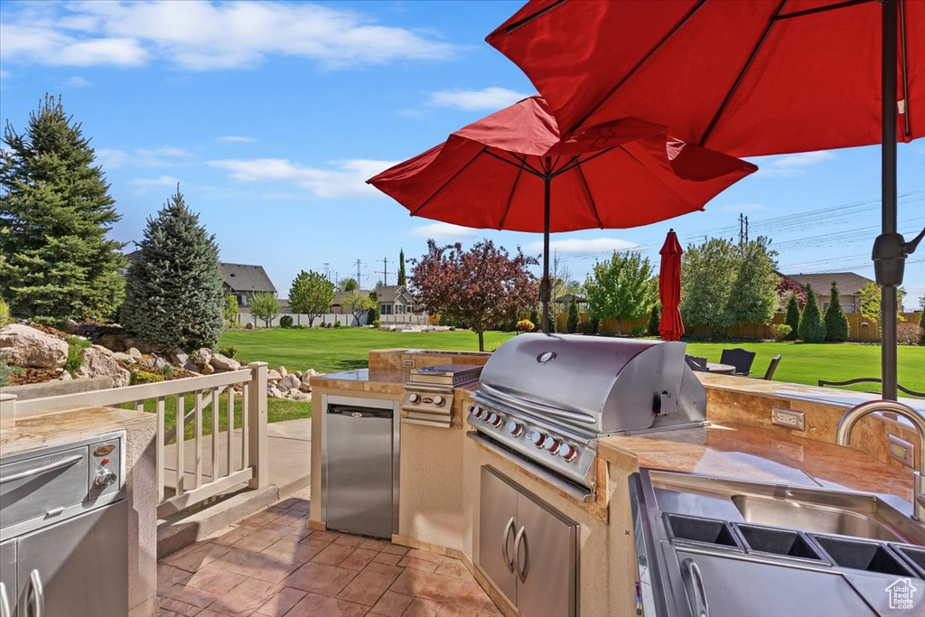 View of patio / terrace with area for grilling and a grill