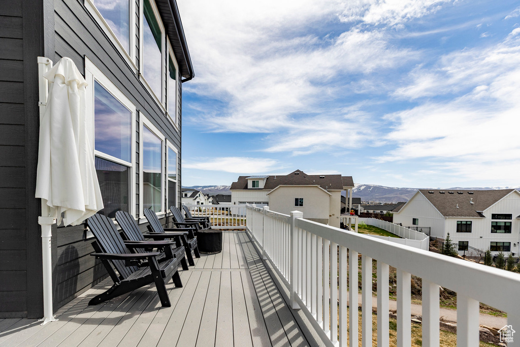 Wooden terrace with a residential view and a mountain view