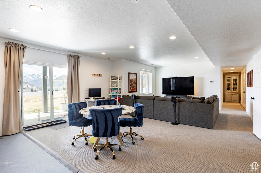 Dining space featuring light colored carpet and recessed lighting