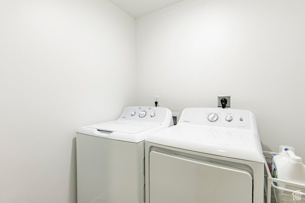 Clothes washing area featuring laundry area and washing machine and clothes dryer