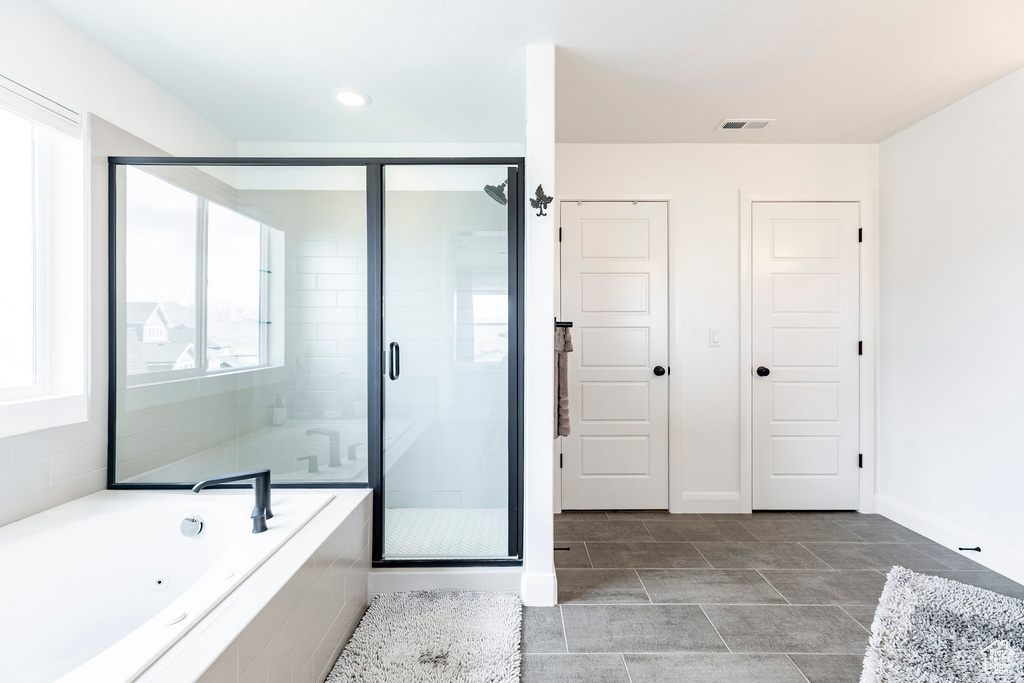 Full bath with a bath, visible vents, a shower stall, baseboards, and recessed lighting