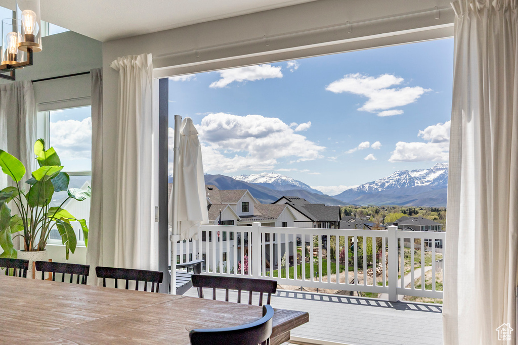 Dining room with a mountain view, a chandelier, and a residential view