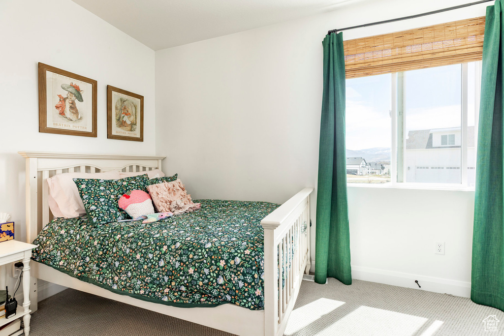 Carpeted bedroom featuring baseboards
