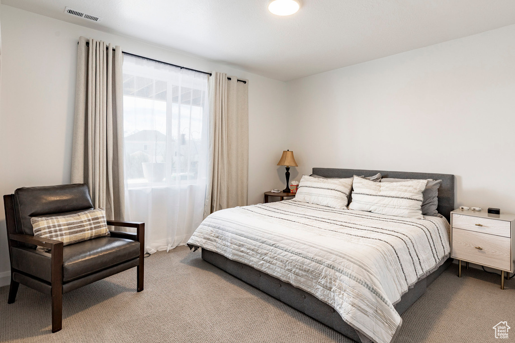 Carpeted bedroom featuring visible vents