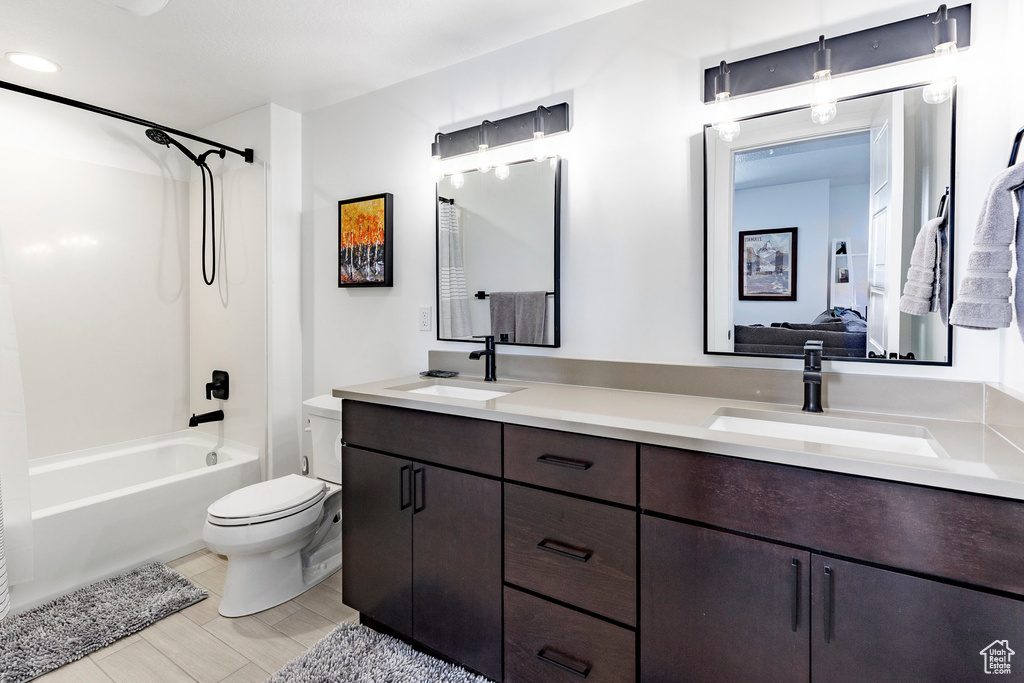 Ensuite bathroom with double vanity, a sink, ensuite bathroom, and toilet