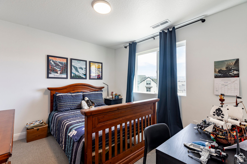 Bedroom with visible vents, carpet, and baseboards