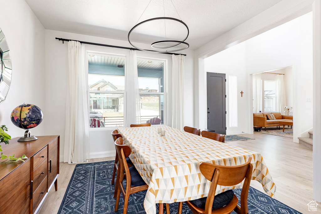 Dining area with light wood-style floors