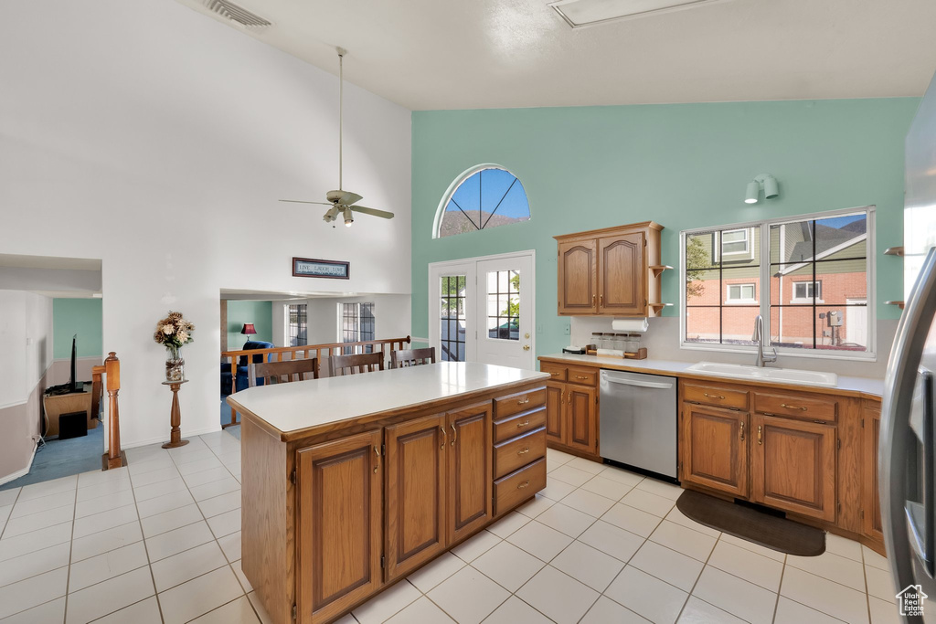 Kitchen with visible vents, a center island, light countertops, a sink, and dishwasher
