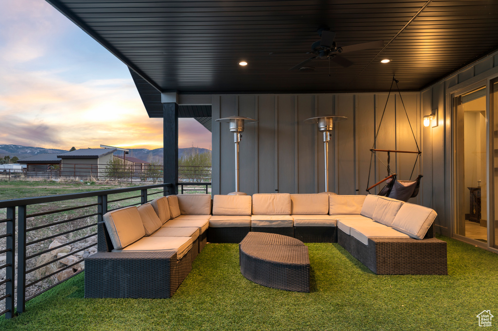 Exterior space with a mountain view, a ceiling fan, and an outdoor hangout area