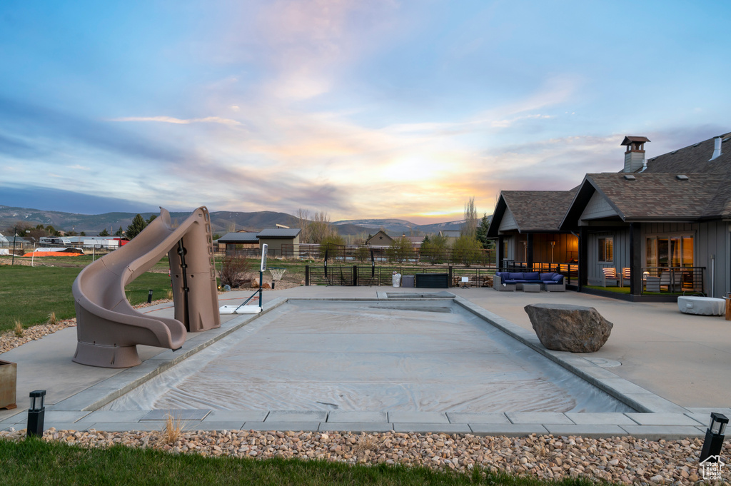 Exterior space with a mountain view, fence, and outdoor lounge area