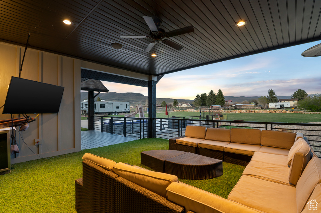 View of patio / terrace featuring outdoor lounge area, ceiling fan, and a mountain view