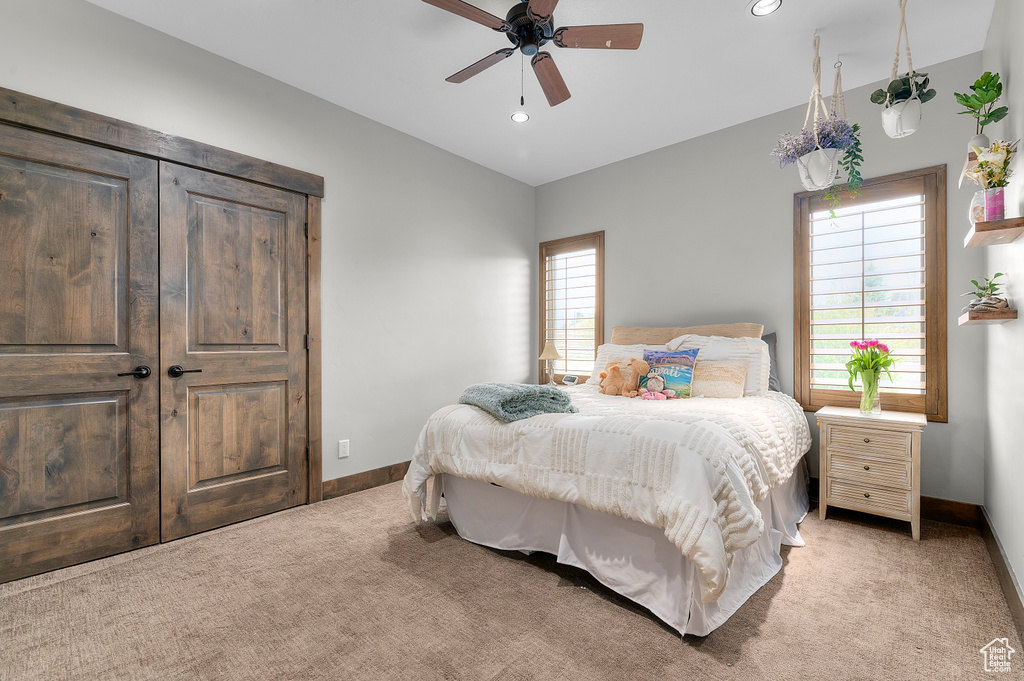 Bedroom featuring light carpet, a ceiling fan, baseboards, and recessed lighting