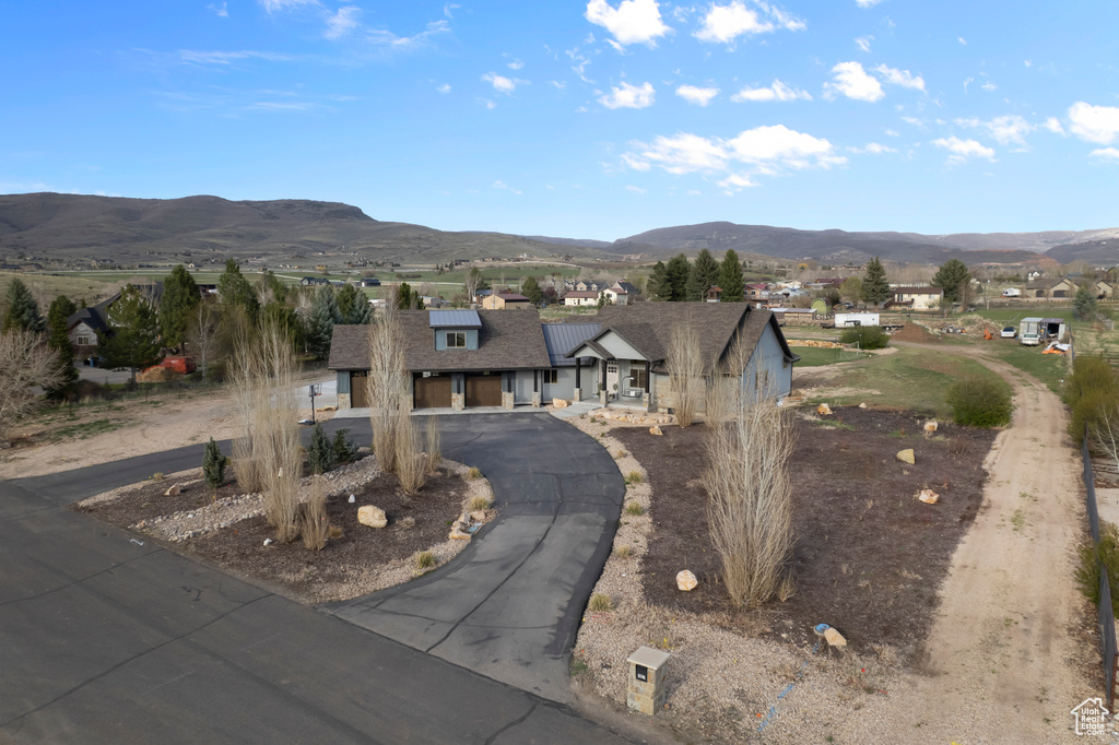 View of front of property featuring curved driveway and a mountain view