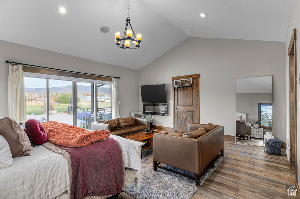 Bedroom featuring high vaulted ceiling, wood finished floors, an inviting chandelier, access to exterior, and recessed lighting