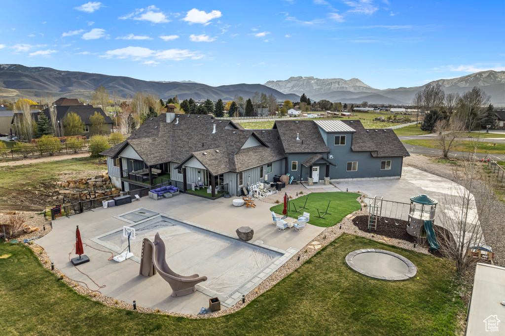 Birds eye view of property with a mountain view
