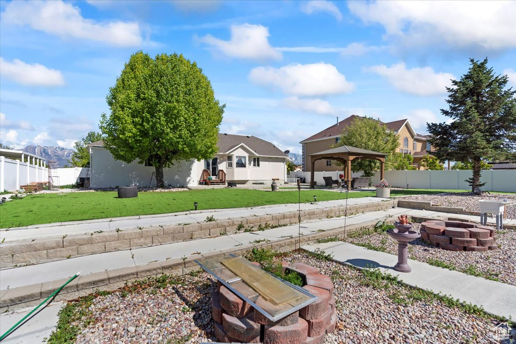 View of yard with a fenced backyard, a gazebo, and a residential view