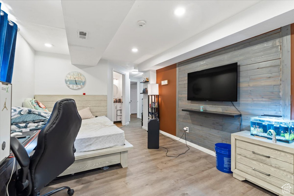Bedroom with visible vents, wood walls, wood finished floors, baseboards, and recessed lighting