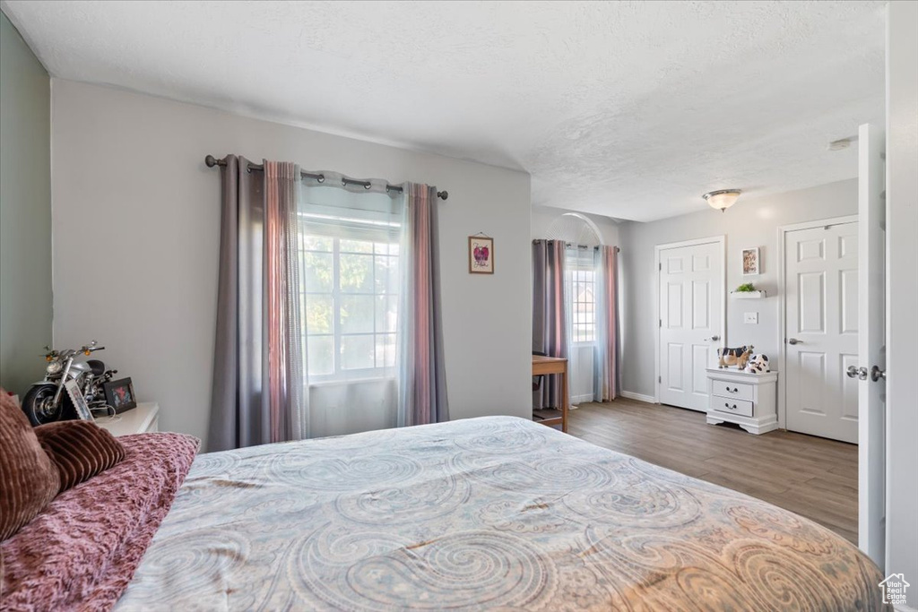 Bedroom featuring a textured ceiling and wood finished floors