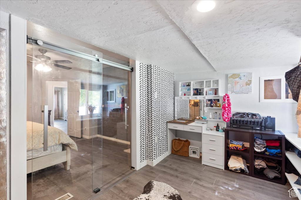 Bathroom featuring a textured ceiling and wood finished floors