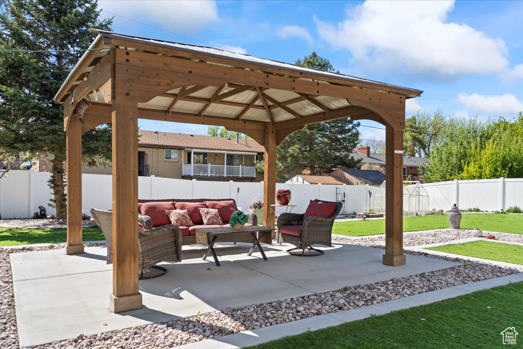 View of patio / terrace featuring a gazebo, an outdoor living space, and a fenced backyard