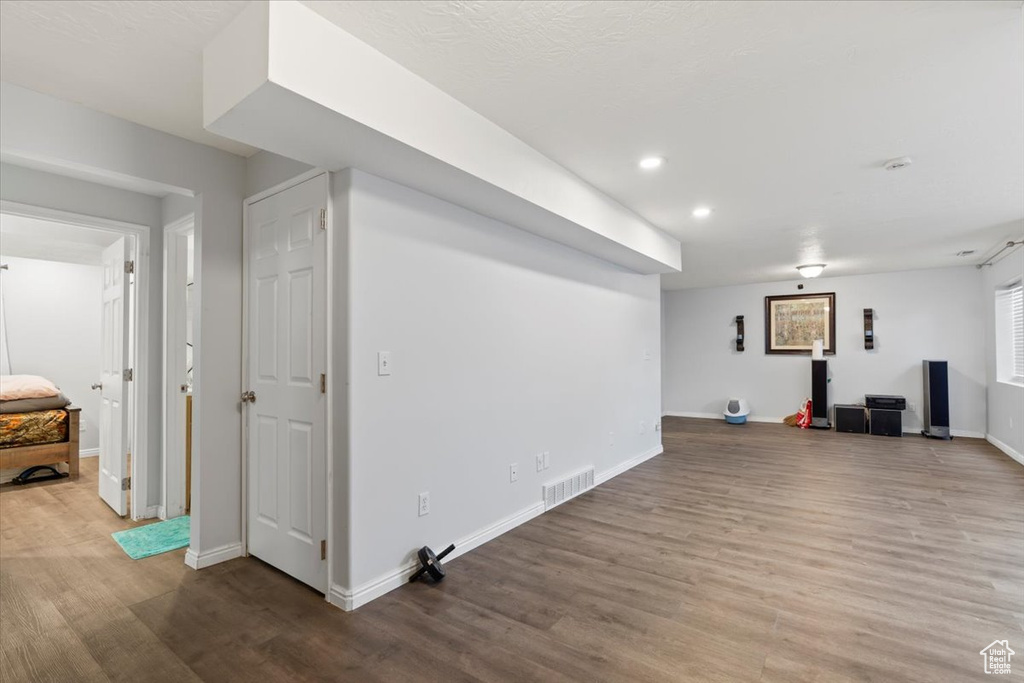 Interior space featuring baseboards, recessed lighting, wood finished floors, and visible vents