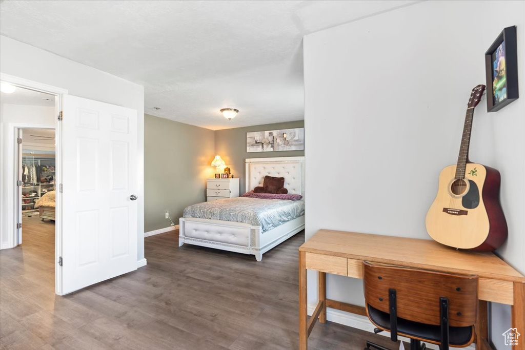 Bedroom featuring baseboards and wood finished floors