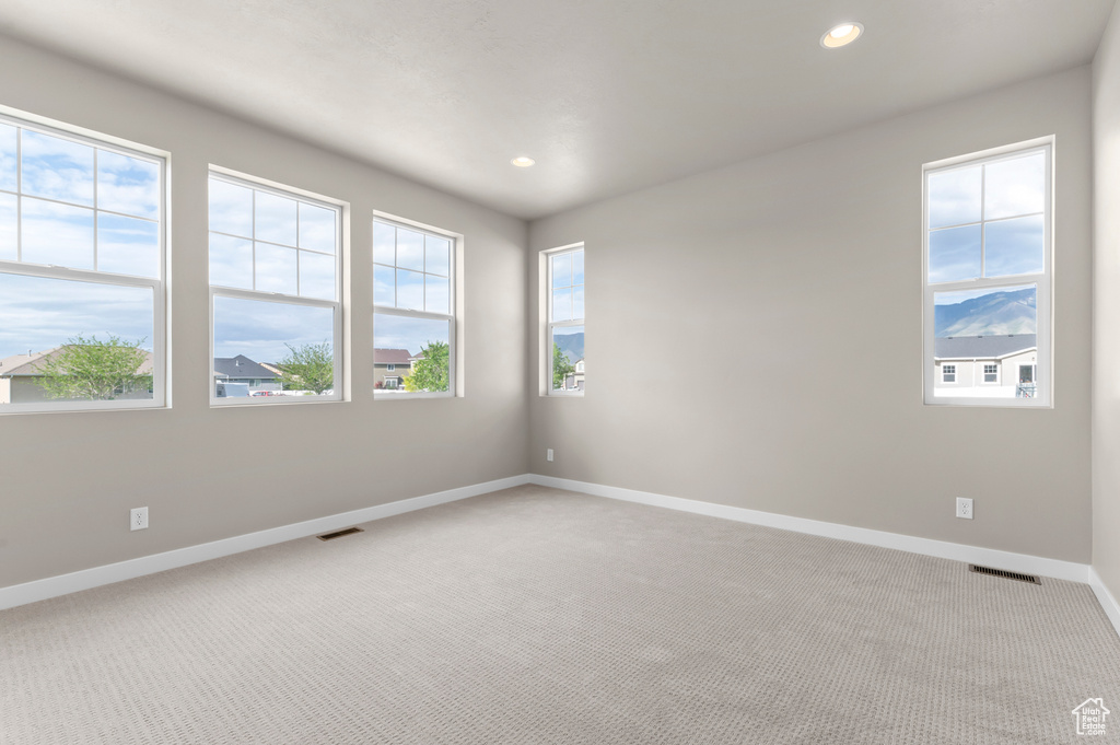 Unfurnished room with light colored carpet, baseboards, and recessed lighting