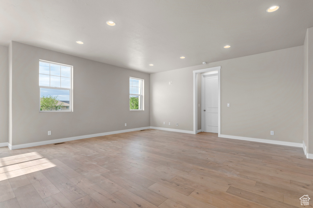 Spare room with baseboards, recessed lighting, and light wood-style flooring