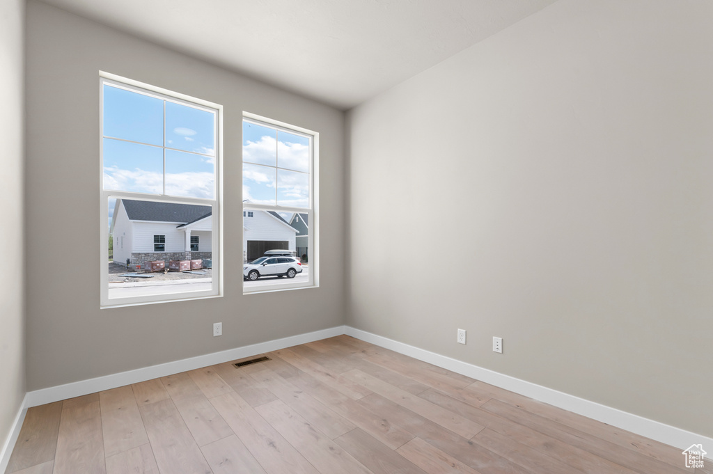 Unfurnished room featuring light wood-style flooring and baseboards