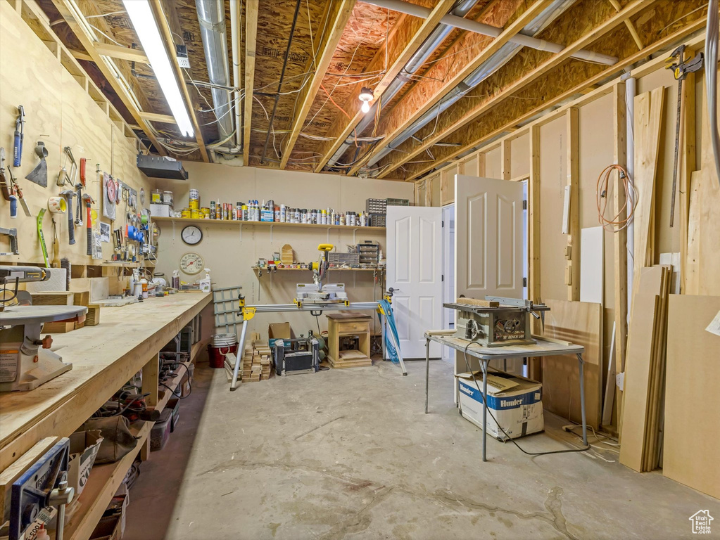 Unfinished basement with a workshop area