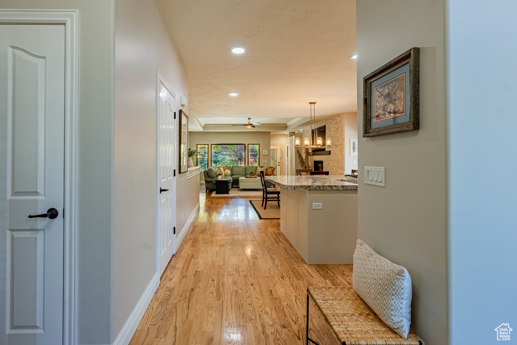 Corridor featuring light wood finished floors and recessed lighting
