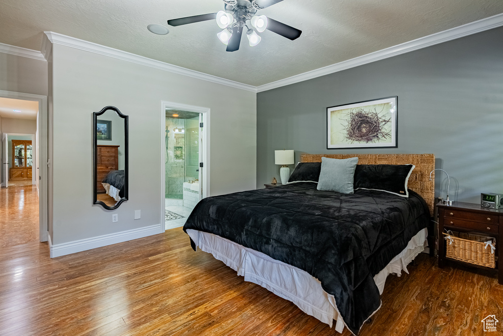 Bedroom featuring wood finished floors, ornamental molding, connected bathroom, and ceiling fan