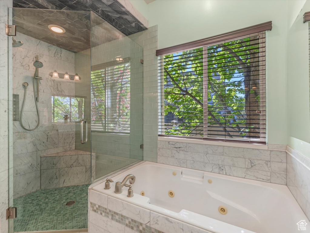 Bathroom with a stall shower and a jetted tub
