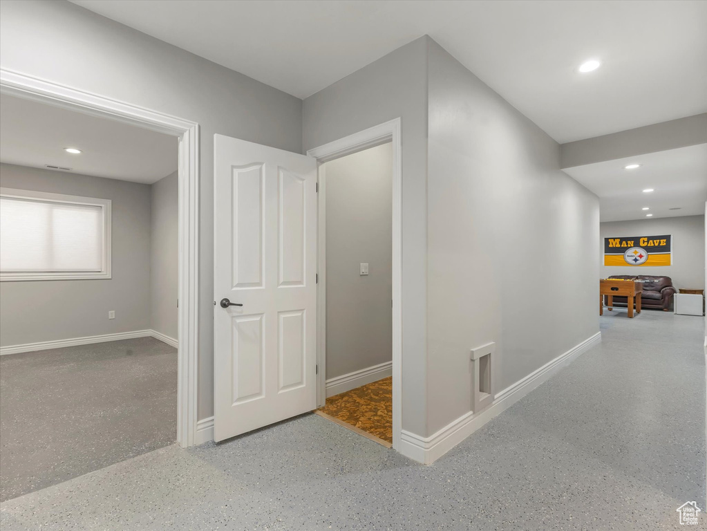 Hall with baseboards, recessed lighting, and speckled floor