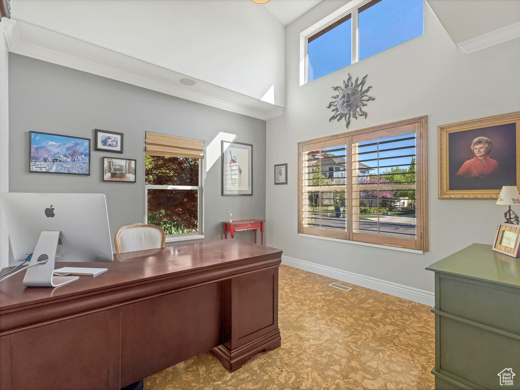Office space featuring baseboards, ornamental molding, tile patterned floors, and visible vents