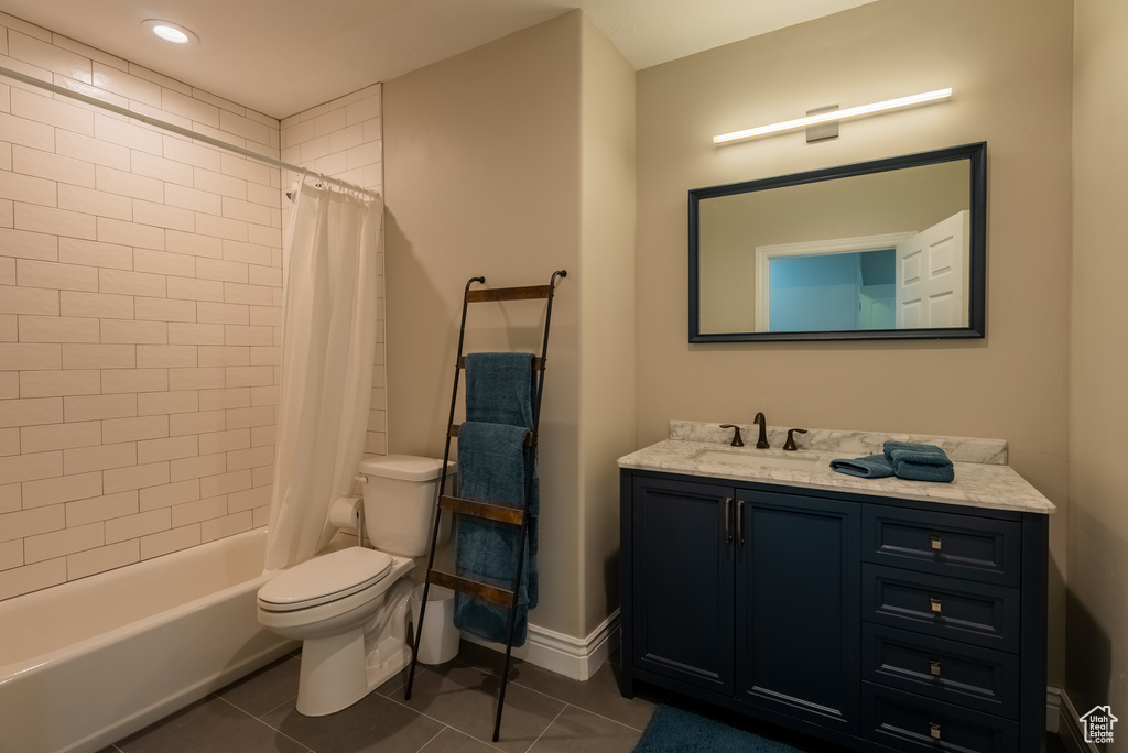 Bathroom featuring vanity, tile patterned floors, and shower / bathtub combination with curtain