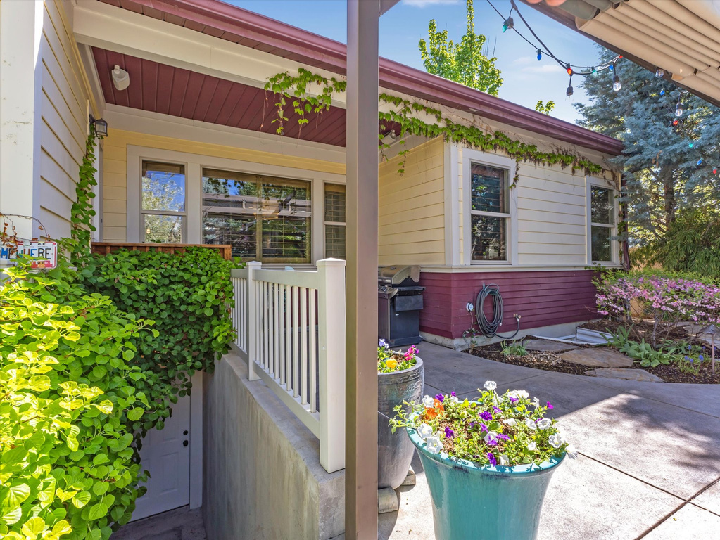 Exterior space with a porch and a grill