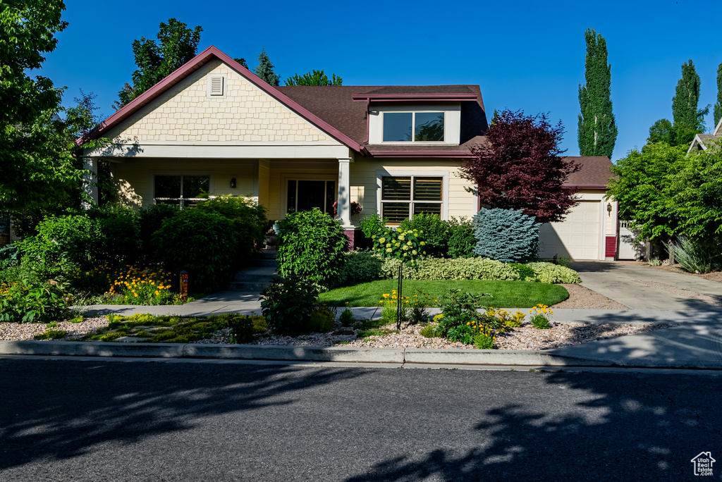 Craftsman inspired home with an attached garage and concrete driveway