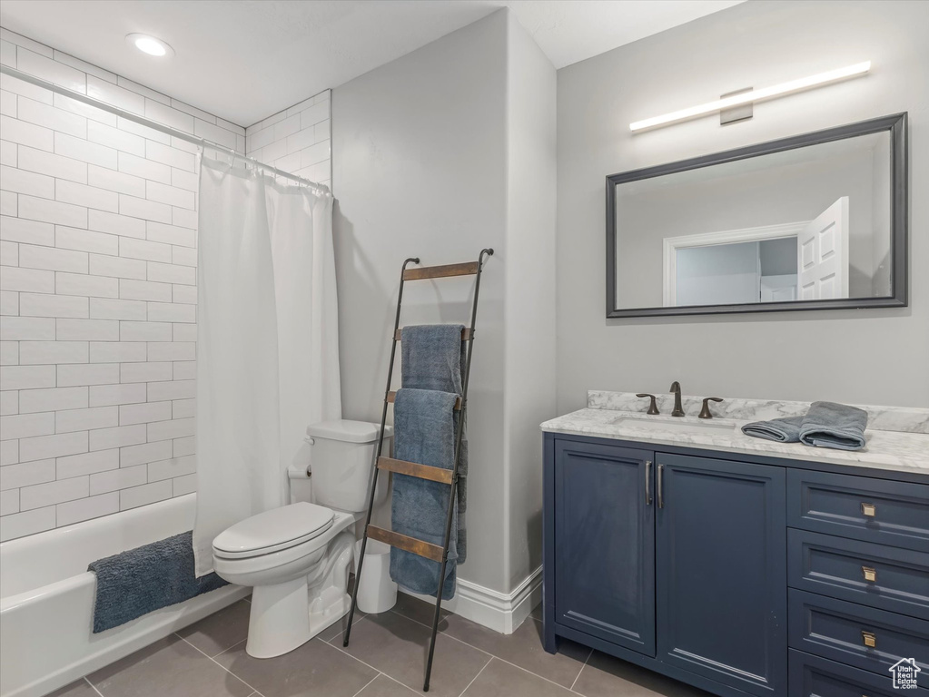 Bathroom featuring tile patterned floors, vanity, and toilet