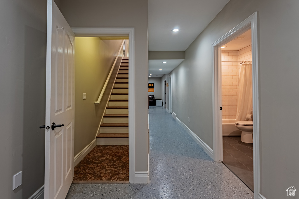 Hall featuring stairs and recessed lighting