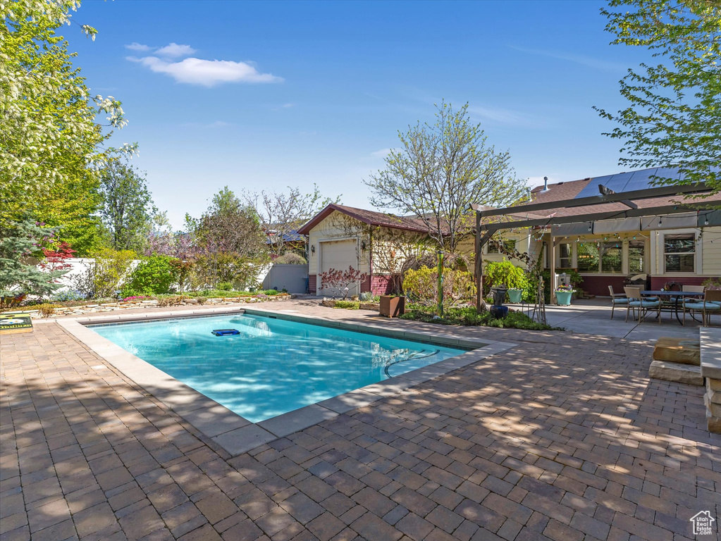 Pool with outdoor dining area and a patio area