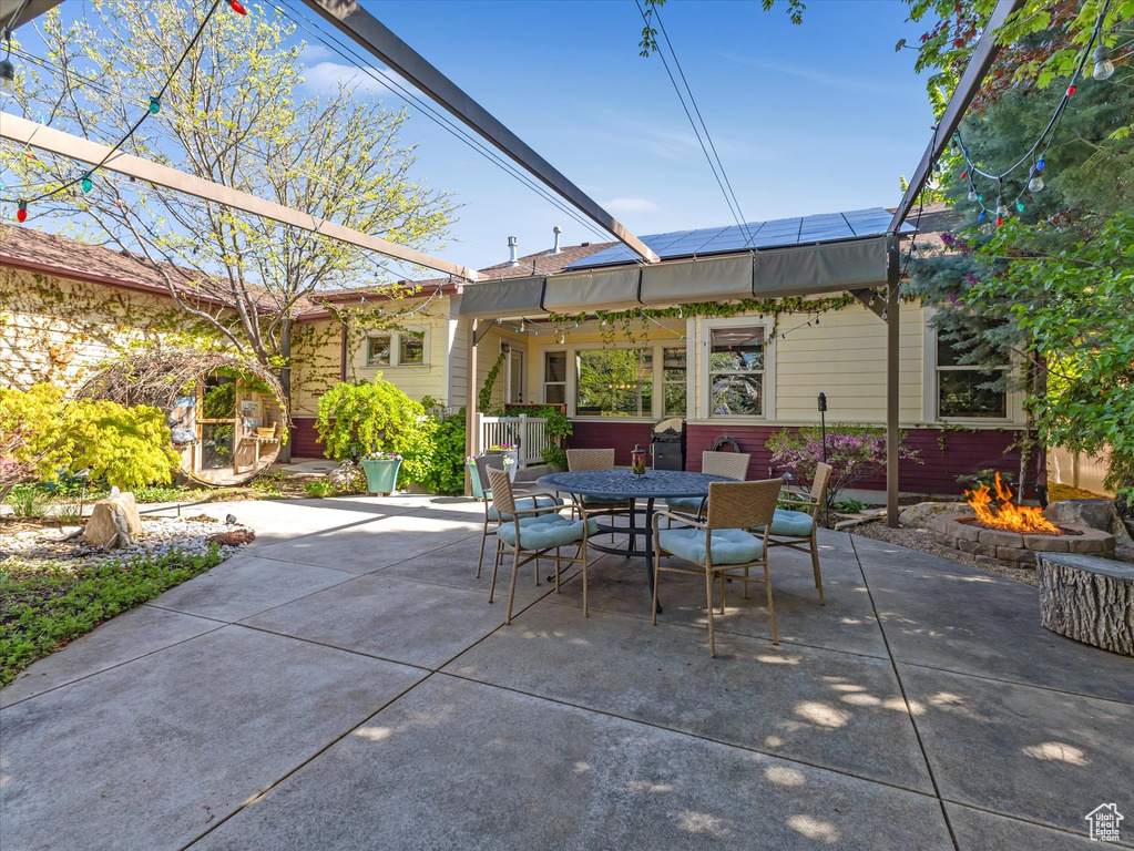 View of patio / terrace with outdoor dining area and an outdoor fire pit