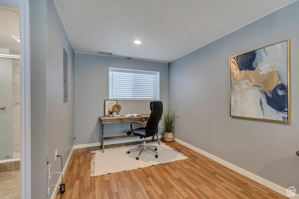 Office space with wood finished floors, recessed lighting, visible vents, and baseboards